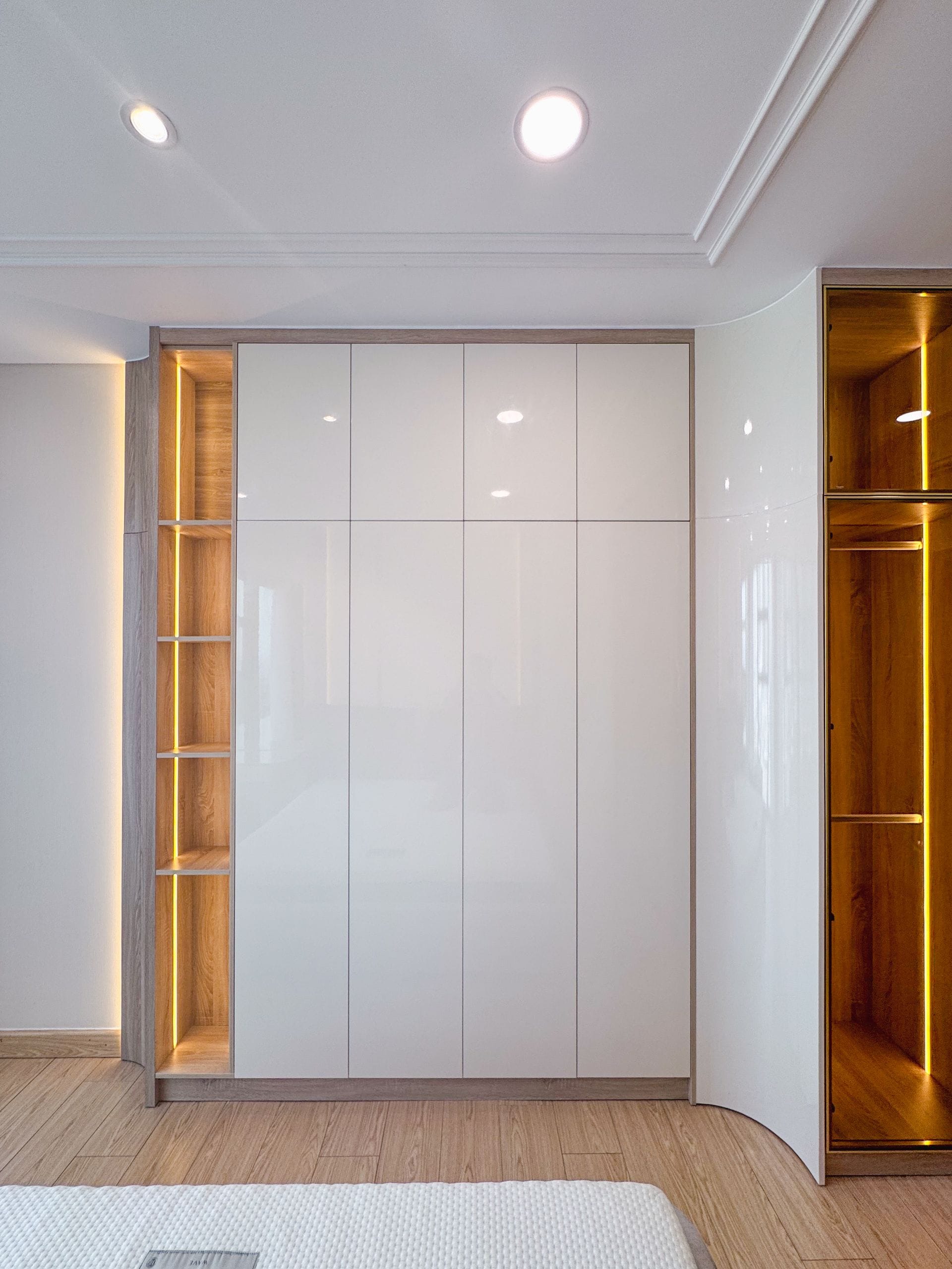 Finished fitted wardrobes with shaker-style doors in a bedroom alcove