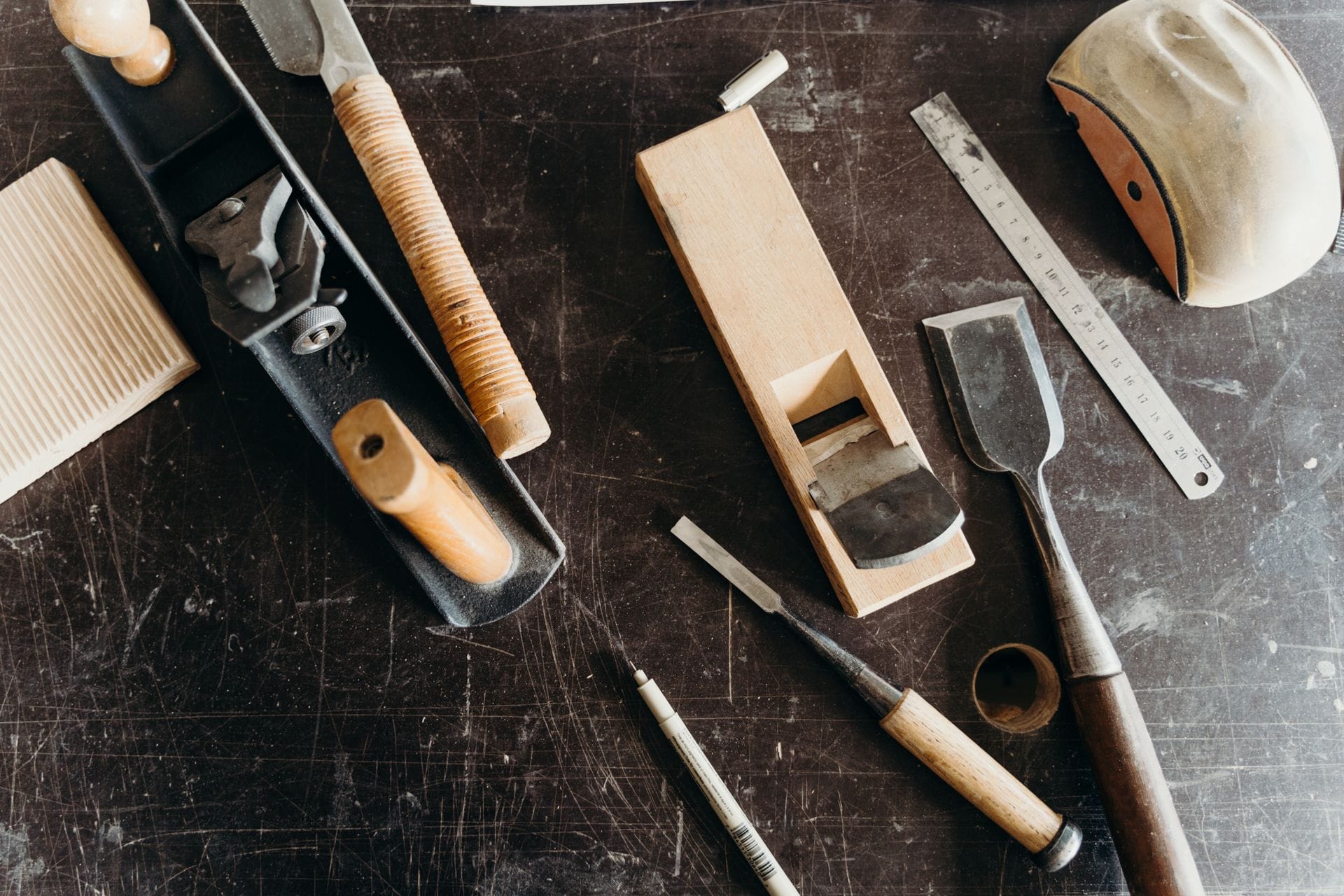 Workshop bench with hand tools and oak boards